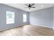 Bedroom featuring two windows letting in natural light and light wood-look flooring at 8355 Fieldfare Way, Indianapolis, IN 46237