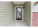Close-up of front door with glass accents and neutral colored siding at 8355 Fieldfare Way, Indianapolis, IN 46237