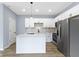 Modern kitchen featuring stainless steel appliances, white cabinets, and a kitchen island at 8355 Fieldfare Way, Indianapolis, IN 46237