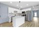 Modern kitchen featuring white cabinets, stainless steel appliances, and kitchen island at 8355 Fieldfare Way, Indianapolis, IN 46237