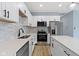 Stylish kitchen with stainless appliances, white cabinetry, and bright lighting at 8355 Fieldfare Way, Indianapolis, IN 46237