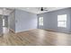 Bright living room boasts neutral paint, wood-look floors, ceiling fan, and lots of natural light at 8355 Fieldfare Way, Indianapolis, IN 46237