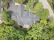 Stunning aerial view of a private home surrounded by lush trees, featuring a deck and winding driveway at 9399 Irishmans Run Ln, Zionsville, IN 46077