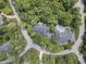 An aerial view showcasing the home's private location, mature trees, and luxurious pool at 9399 Irishmans Run Ln, Zionsville, IN 46077