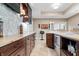 Bar area showcasing wood cabinets, stainless steel appliances, and tiled backsplash at 9399 Irishmans Run Ln, Zionsville, IN 46077