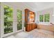 A luxurious bathroom with tub, vanity, and French doors leading to a balcony at 9399 Irishmans Run Ln, Zionsville, IN 46077