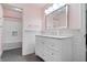 Pink bathroom with a white vanity, marble countertop, and a tub at 9399 Irishmans Run Ln, Zionsville, IN 46077