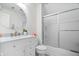 Bright bathroom featuring marble vanity, shower stall and oval mirror at 9399 Irishmans Run Ln, Zionsville, IN 46077