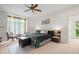 Comfortable bedroom featuring carpet flooring, a ceiling fan, and natural light at 9399 Irishmans Run Ln, Zionsville, IN 46077