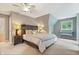 Inviting bedroom with a rustic headboard, plush bedding, and natural light from the window at 9399 Irishmans Run Ln, Zionsville, IN 46077