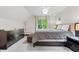 Relaxing bedroom with a window view, a dresser, and comfortable seating at 9399 Irishmans Run Ln, Zionsville, IN 46077