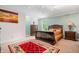 Cozy carpeted bedroom featuring a sleigh bed and soft, natural light at 9399 Irishmans Run Ln, Zionsville, IN 46077