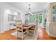 Dining room featuring a modern chandelier, ample seating, and elegant decor at 9399 Irishmans Run Ln, Zionsville, IN 46077