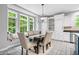 Cozy dining room featuring natural light, a window seat, and white cabinetry with stainless steel appliances at 9399 Irishmans Run Ln, Zionsville, IN 46077