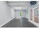 Bright workout room with rubber floor, skylight, ceiling fan, and french doors at 9399 Irishmans Run Ln, Zionsville, IN 46077