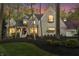 Stunning brick home with professional landscaping, elegant porch, and warm lighting at 9399 Irishmans Run Ln, Zionsville, IN 46077