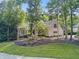 Charming brick home with a landscaped yard featuring mature trees and lush greenery at 9399 Irishmans Run Ln, Zionsville, IN 46077