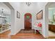 Inviting foyer featuring hardwood floors, a wooden door, and elegant decor at 9399 Irishmans Run Ln, Zionsville, IN 46077