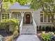 Charming entrance with a natural wood door, complemented by landscaped greenery at 9399 Irishmans Run Ln, Zionsville, IN 46077