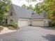 Spacious three car garage and driveway of home with charming brick exterior and manicured landscaping at 9399 Irishmans Run Ln, Zionsville, IN 46077
