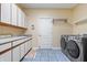 Functional laundry room featuring ample storage and modern appliances at 9399 Irishmans Run Ln, Zionsville, IN 46077