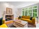 Bright living room featuring a fireplace, a large window, and stylish furnishings at 9399 Irishmans Run Ln, Zionsville, IN 46077