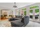 Spacious living room with backyard access, an oversized sectional and an open floor plan at 9399 Irishmans Run Ln, Zionsville, IN 46077