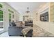 Open concept living room boasts built-in shelving, a large sectional, and seamless access to the kitchen at 9399 Irishmans Run Ln, Zionsville, IN 46077