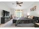 Comfortable main bedroom featuring a ceiling fan, a TV, and natural light at 9399 Irishmans Run Ln, Zionsville, IN 46077