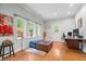 Sun-filled home office with hardwood floors, built-in desk, and large windows at 9399 Irishmans Run Ln, Zionsville, IN 46077