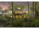 Stunning brick home with a private balcony surrounded by lush greenery and mature trees at 9399 Irishmans Run Ln, Zionsville, IN 46077