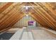 Large attic space with exposed wood beams and flooring at 9703 Fortune Dr, Fishers, IN 46037