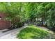 Landscaped backyard with lush greenery, brick edging, and a wrought iron gate at 9703 Fortune Dr, Fishers, IN 46037