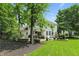 Spacious backyard with a well-maintained lawn, mature trees, and a cozy patio area, perfect for relaxation at 9703 Fortune Dr, Fishers, IN 46037