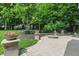 Relaxing backyard with an outdoor fireplace, stone patio, and beautiful landscaping at 9703 Fortune Dr, Fishers, IN 46037