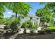 A serene backyard with a stone patio, manicured landscaping, and mature trees offering a private outdoor retreat at 9703 Fortune Dr, Fishers, IN 46037