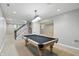 Finished basement featuring a pool table, staircase, and neutral color palette at 9703 Fortune Dr, Fishers, IN 46037