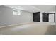 Spacious finished basement with carpet flooring, natural light, and neutral color scheme at 9703 Fortune Dr, Fishers, IN 46037