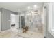 Bathroom with a clear glass shower featuring marble-style tiles, and views into the next room at 9703 Fortune Dr, Fishers, IN 46037