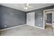 Neutral bedroom featuring a closet, ceiling fan, and entrance to another room at 9703 Fortune Dr, Fishers, IN 46037