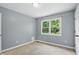 Neutral bedroom featuring natural light and a large window overlooking greenery at 9703 Fortune Dr, Fishers, IN 46037