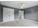 View of a carpeted bedroom showing a closet and a doorway leading into another room at 9703 Fortune Dr, Fishers, IN 46037