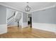 Dining room featuring modern light fixture, chair rail molding, hardwood floors, and views to the staircase at 9703 Fortune Dr, Fishers, IN 46037