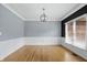 Spacious dining room with modern lighting, chair rail molding, and hardwood floors perfect for entertaining at 9703 Fortune Dr, Fishers, IN 46037