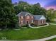 Charming brick home with manicured landscaping and a lush green lawn at 9703 Fortune Dr, Fishers, IN 46037
