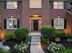 Inviting front entrance with a black door, manicured bushes, and stone walkway at 9703 Fortune Dr, Fishers, IN 46037