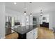 Open concept kitchen with island, stainless steel appliances, and view into living room at 9703 Fortune Dr, Fishers, IN 46037
