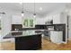 Charming kitchen with a view to the backyard, center island, stainless appliances, and wood floors at 9703 Fortune Dr, Fishers, IN 46037