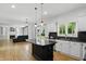 Charming kitchen with stainless appliances, center island, and open layout to living room and backyard at 9703 Fortune Dr, Fishers, IN 46037