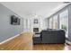 Bright living room with hardwood floors, fireplace, built-in shelves, and large windows at 9703 Fortune Dr, Fishers, IN 46037